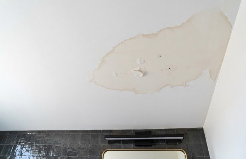 Paint Peeling in Bathroom Ceiling? In KY, Winter Steam Is Mostly Why 2 Brown water ring and bubbled paint on a bathroom ceiling above a vanity