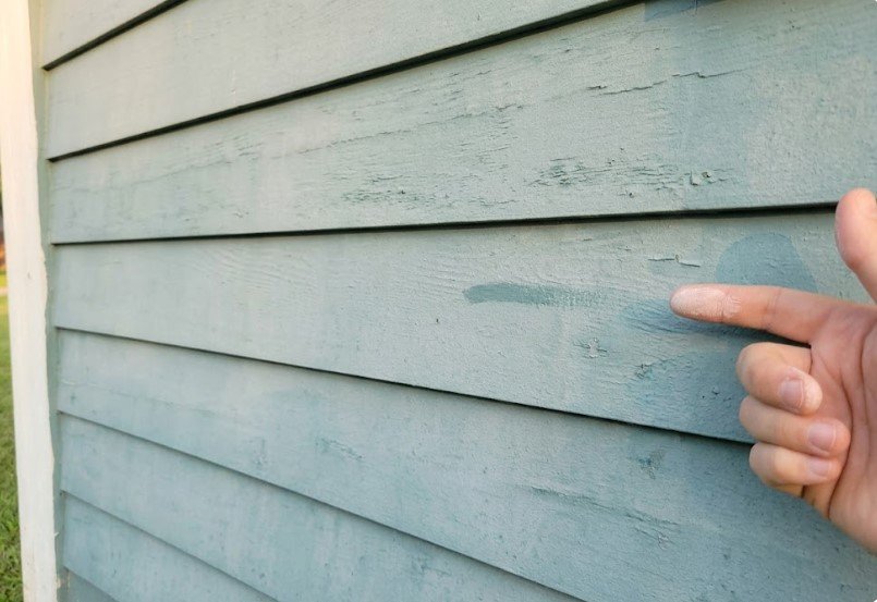 Exterior Paint Problems and Solutions: Why Peeling Sills and Mildew Dominate in KY 4 Finger covered in white chalk after wiping faded teal exterior siding